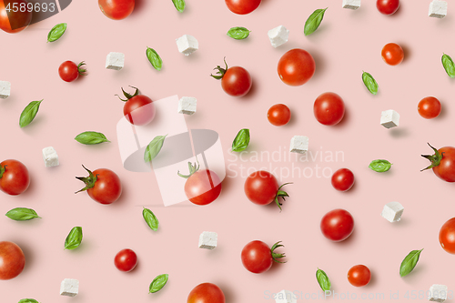 Image of Juicy fresh organic tomatoes pattern with cheese and basil.