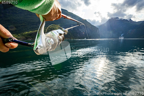 Image of Woman fishing on Fishing rod spinning in Norway.