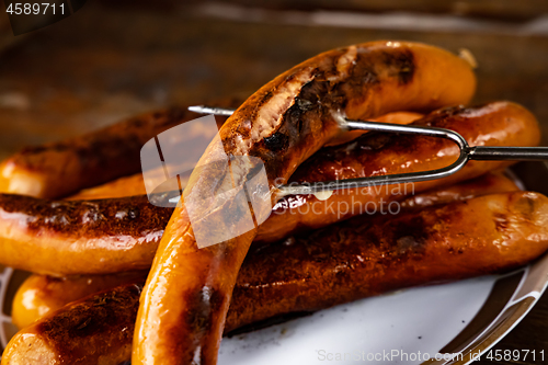 Image of Grilled sausages on wooden board