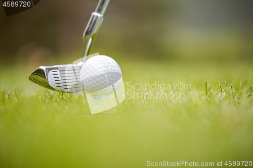 Image of Golf ball on tee in front of driver