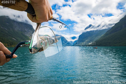 Image of Woman fishing on Fishing rod spinning in Norway.