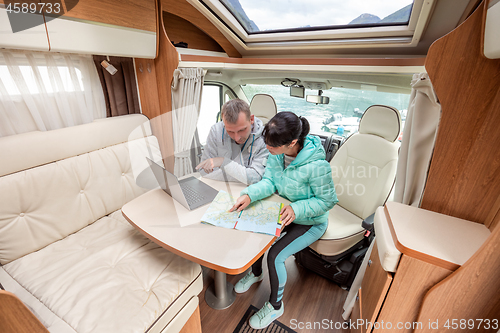 Image of Couples in RV Camper looking at the local map for the trip.