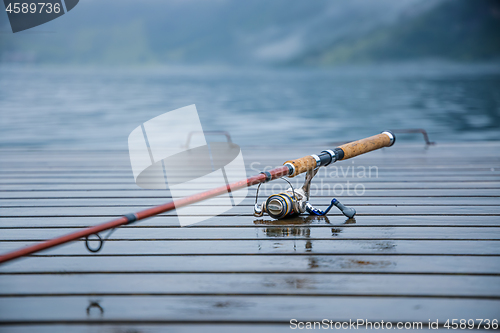 Image of Fishing rod spinning blurred background