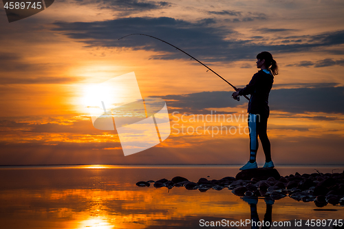 Image of Woman fishing on Fishing rod spinning in Norway.