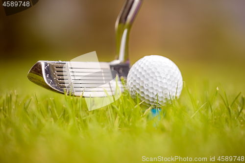 Image of Golf ball on tee in front of driver