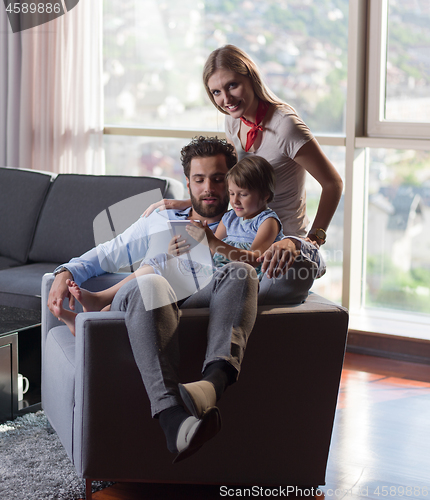 Image of happy young couple spending time with kids