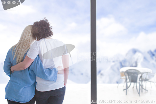 Image of young couple enjoying morning coffee by the window