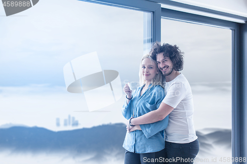 Image of young couple enjoying morning coffee by the window