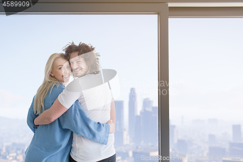 Image of young couple enjoying morning coffee by the window