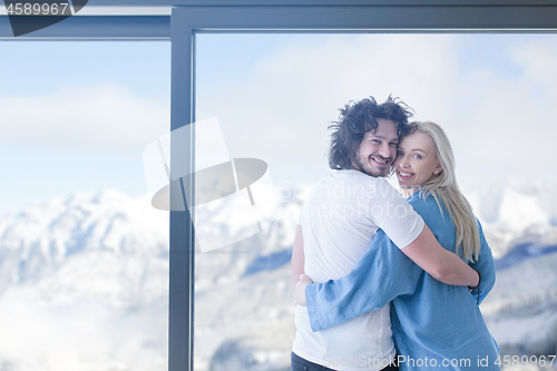 Image of young couple enjoying morning coffee by the window