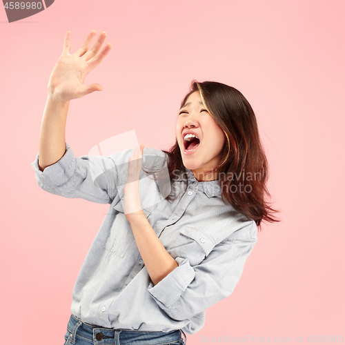 Image of Portrait of the scared woman on pink