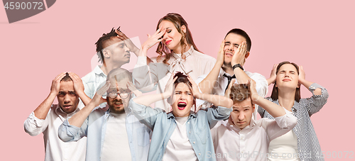 Image of People having headache. Isolated over pink background.