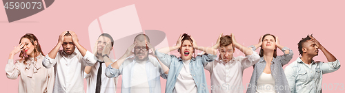 Image of People having headache. Isolated over pink background.