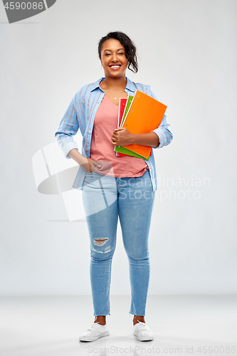 Image of african american student woman with notebooks