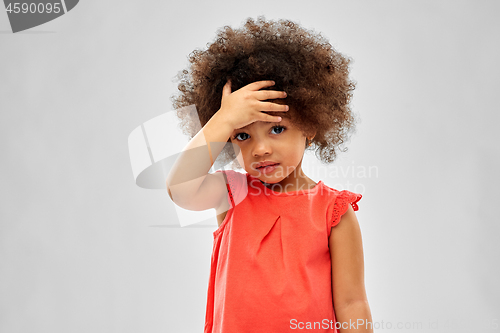 Image of sad little african american girl touching forehead