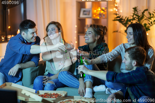 Image of friends with drinks and pizza watching tv at home