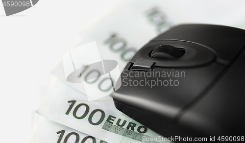 Image of close up of computer mouse on euro money