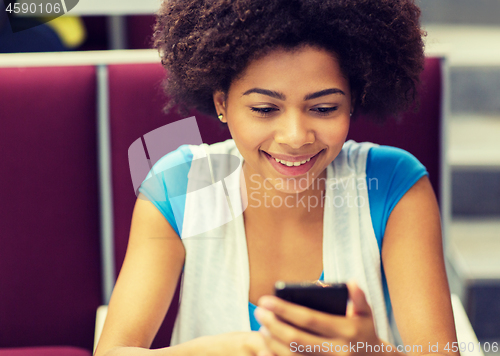 Image of african student girl with smartphone on lecture