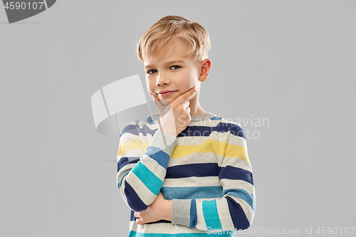 Image of portrait of thinking boy in striped pullover