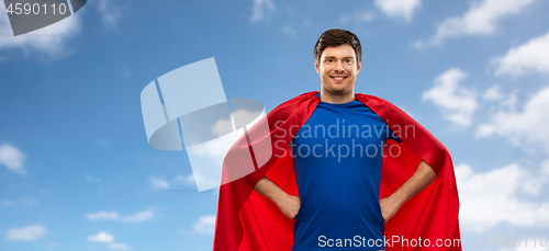 Image of man in red superhero cape over sky background