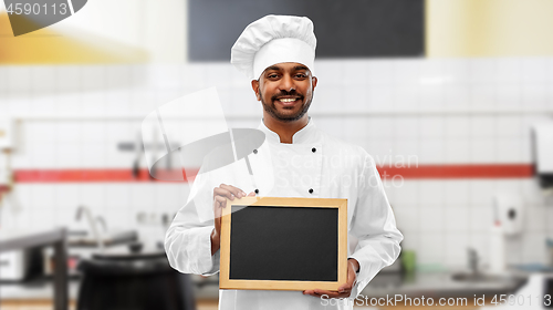 Image of indian chef with chalkboard at restaurant kitchen
