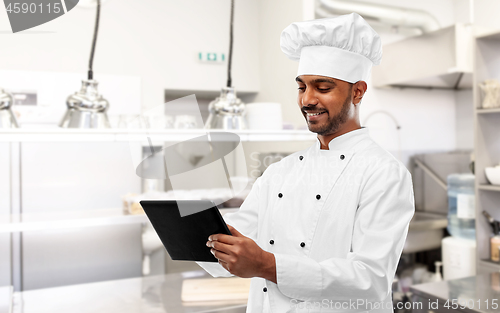 Image of indian chef with tablet pc at restaurant kitchen