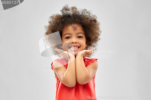 Image of happy little african american girl over grey