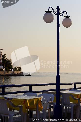 Image of sunset over fishing village in greece