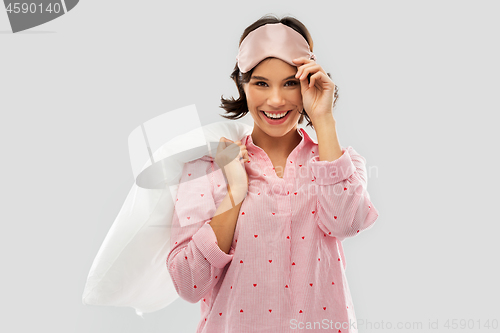 Image of woman with pillow in pajama and eye sleeping mask
