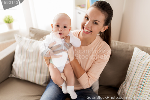 Image of happy mother with little baby boy at home