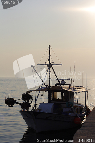 Image of sunset over fishing village in greece