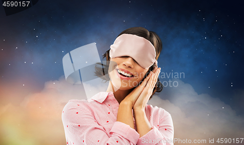 Image of happy young woman in pajama and eye sleeping mask