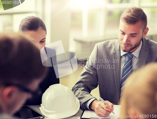 Image of architects with helmet and clipboard at office