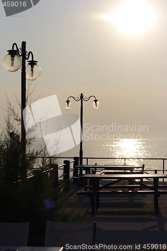 Image of sunset over fishing village in greece