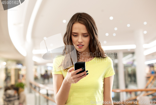 Image of young woman or teenage girl using smartphone