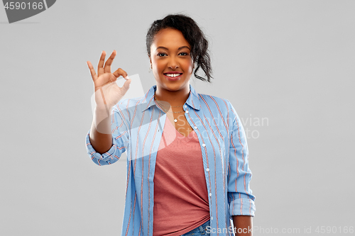 Image of happy african american woman showing ok hand sign