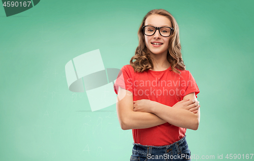 Image of smiling student girl in glasses over green board