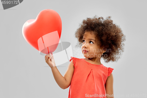 Image of african american girl with heart shaped balloon