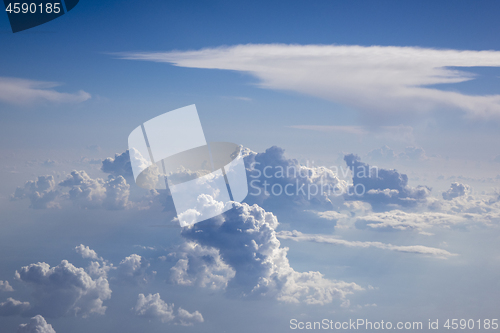 Image of Big fluffy clouds on a blue sky background.