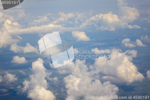 Image of White clouds in the sky above country landscape.