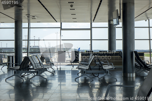 Image of Contemporary airport hall interior with empty chairs.