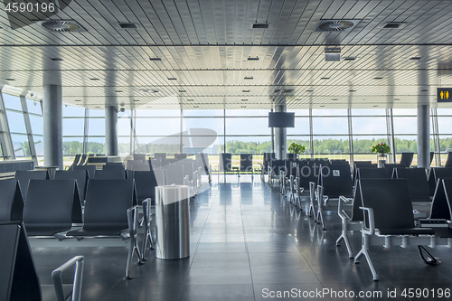 Image of Modern airport waiting hall interior with empty chairs.