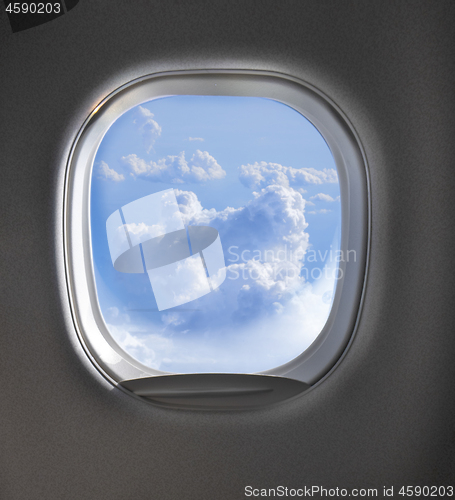 Image of Aerial view of cloudy sky through airplaine window.