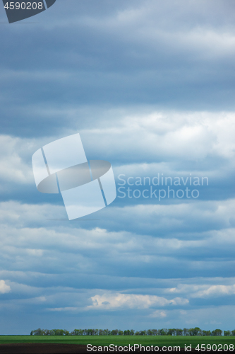 Image of Farmland landscape on a background of cloudy sky.