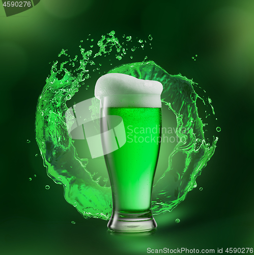 Image of Glass of beer drink with green splash behind it.