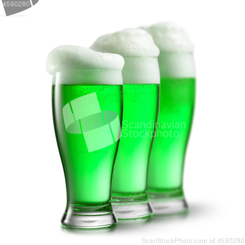 Image of Green beer in glasses isolated on white background