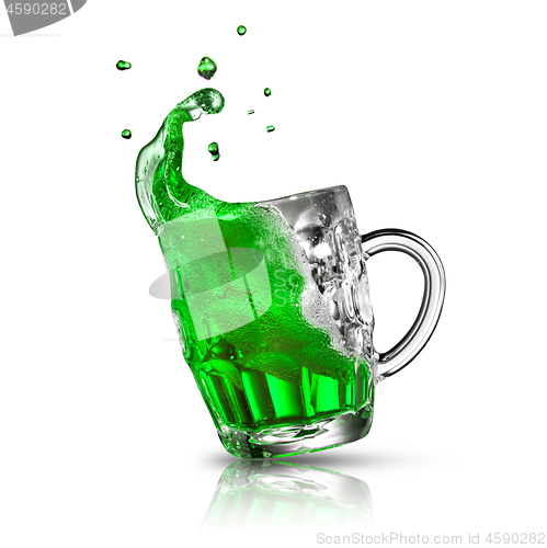 Image of Green alcoholic drink splash in a beer mug on a white.