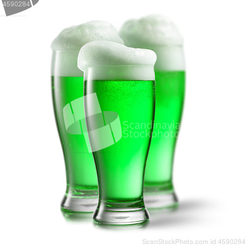 Image of Alcoholic green beer in the glasses on a white.