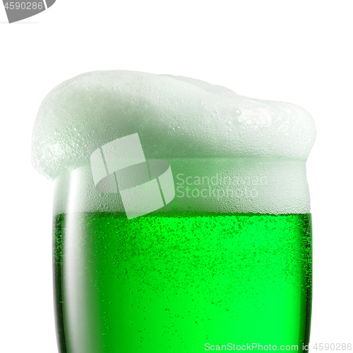 Image of Macro view of extra foam on top of green beer drink.