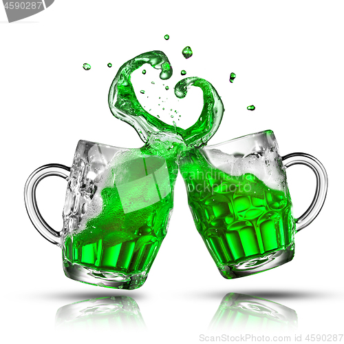 Image of Two bouncing beer mugs with green drink splashes.